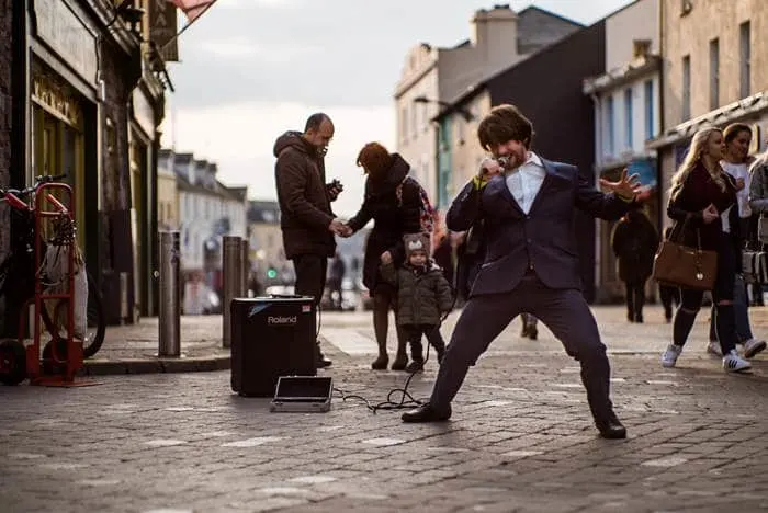 Lively Quay street for shops and live music in Galway city, Irleand