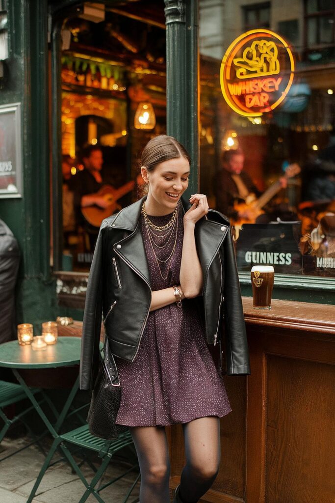 Smiling woman in chic leather jacket outside a cozy whiskey bar with live music and a pint of Guinness.