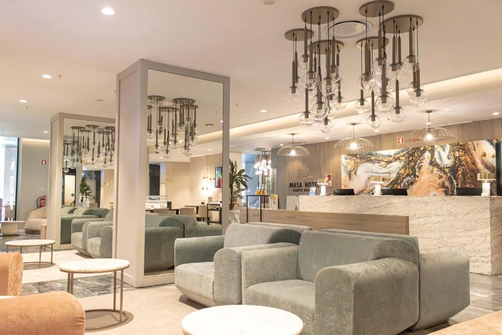 Modern hotel lobby with plush seating, contemporary lighting, and stylish reception desk.
