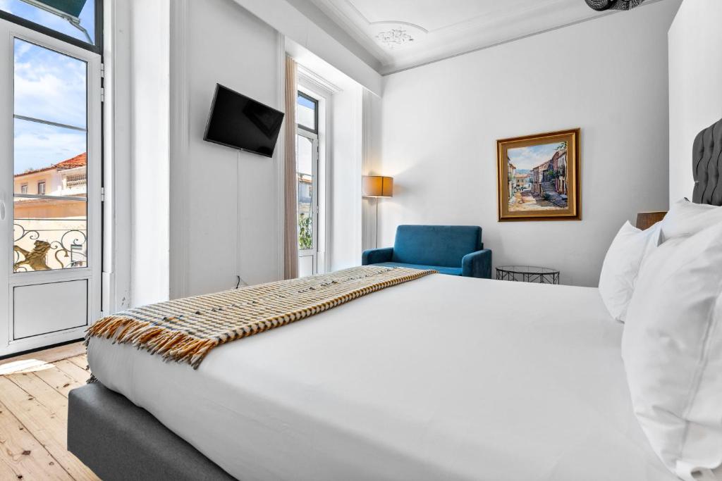 Bright hotel room with a cozy bed, modern decor, large windows, and a street-view balcony for a relaxing stay.