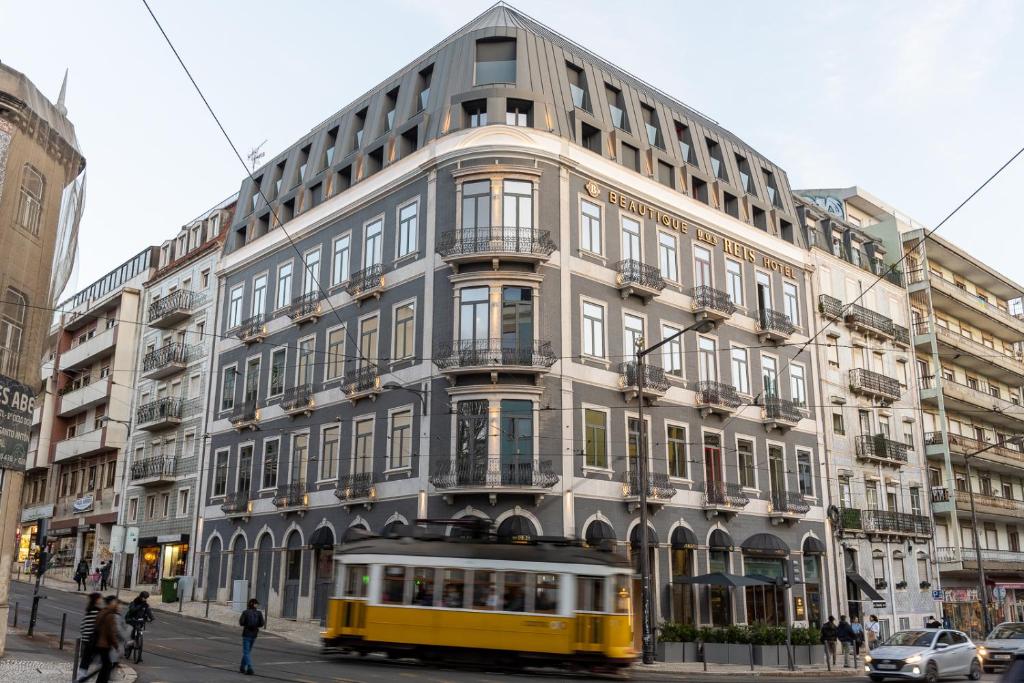 Historic city building with tram in front on an urban street corner, showcasing European architecture.