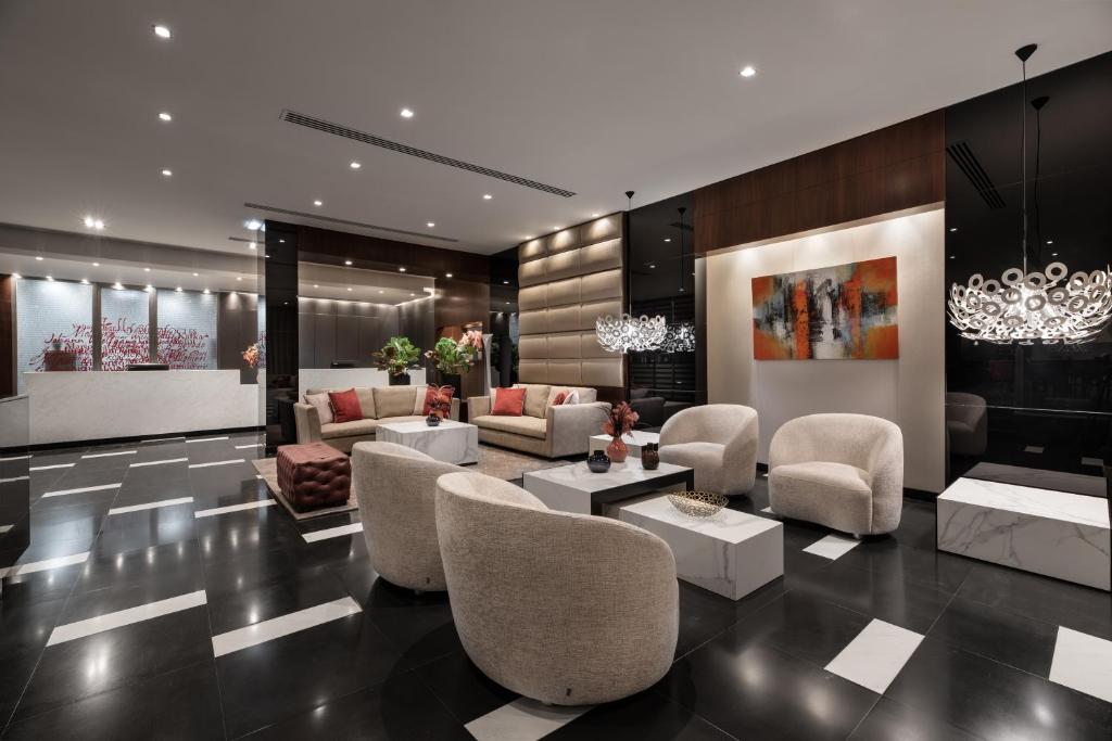 Modern hotel lobby with elegant seating, contemporary art, and stylish lighting fixtures.