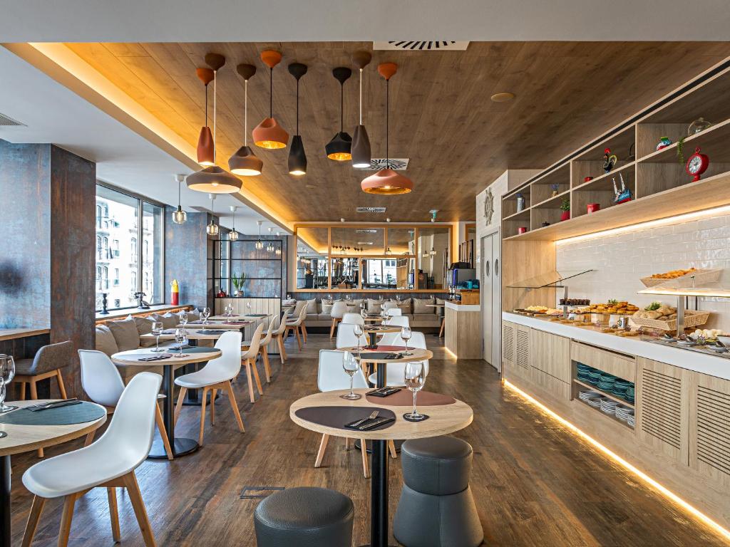 Modern restaurant interior with elegant decor, stylish lighting, wooden accents, and buffet setup.