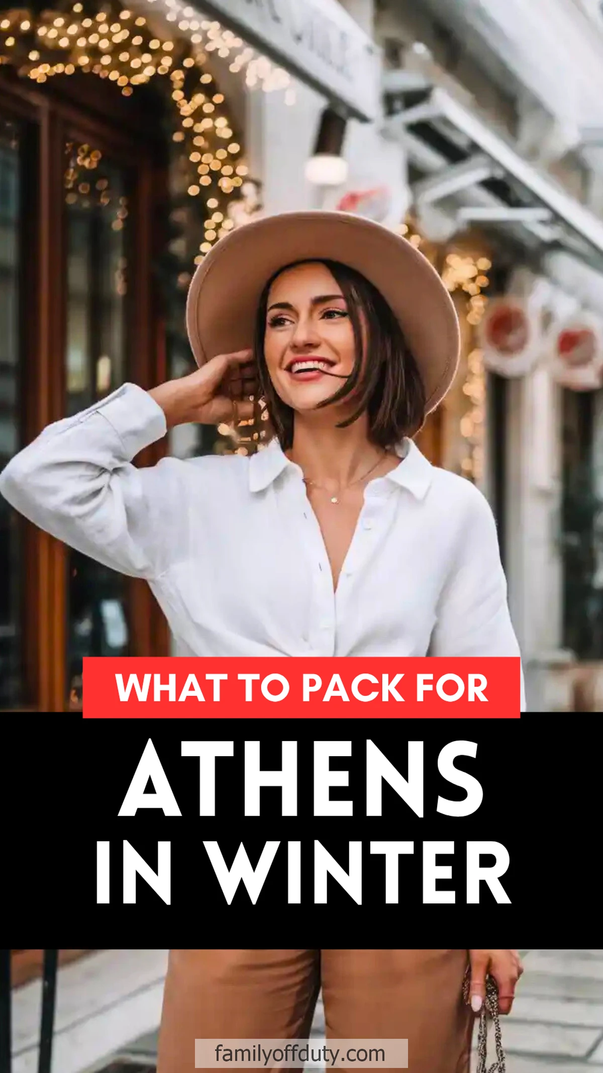 Woman in stylish winter attire for an outdoor walk in Athens, with festive lights in the background.