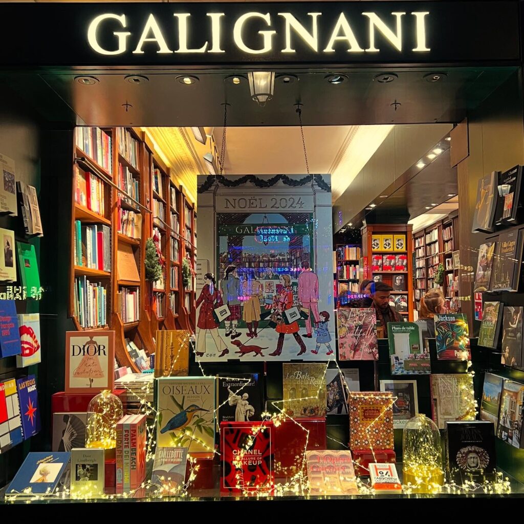 Cozy bookstore decorated for Christmas 2024 with books on display and festive lights in Paris.