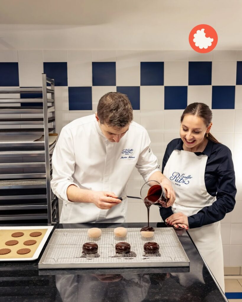 Chefs decorating desserts with chocolate glaze in a bakery kitchen, smiling and concentrating on their work.