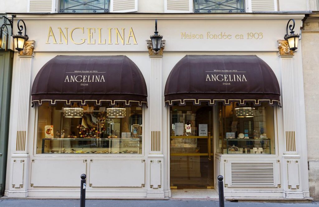 Front view of Angelina Paris patisserie with elegant entrance and display. Founded in 1903.
