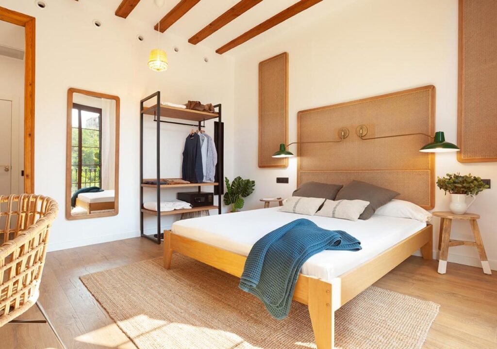 Cozy bedroom featuring wooden accents, a stylish mirror, and modern decor for a relaxing atmosphere.