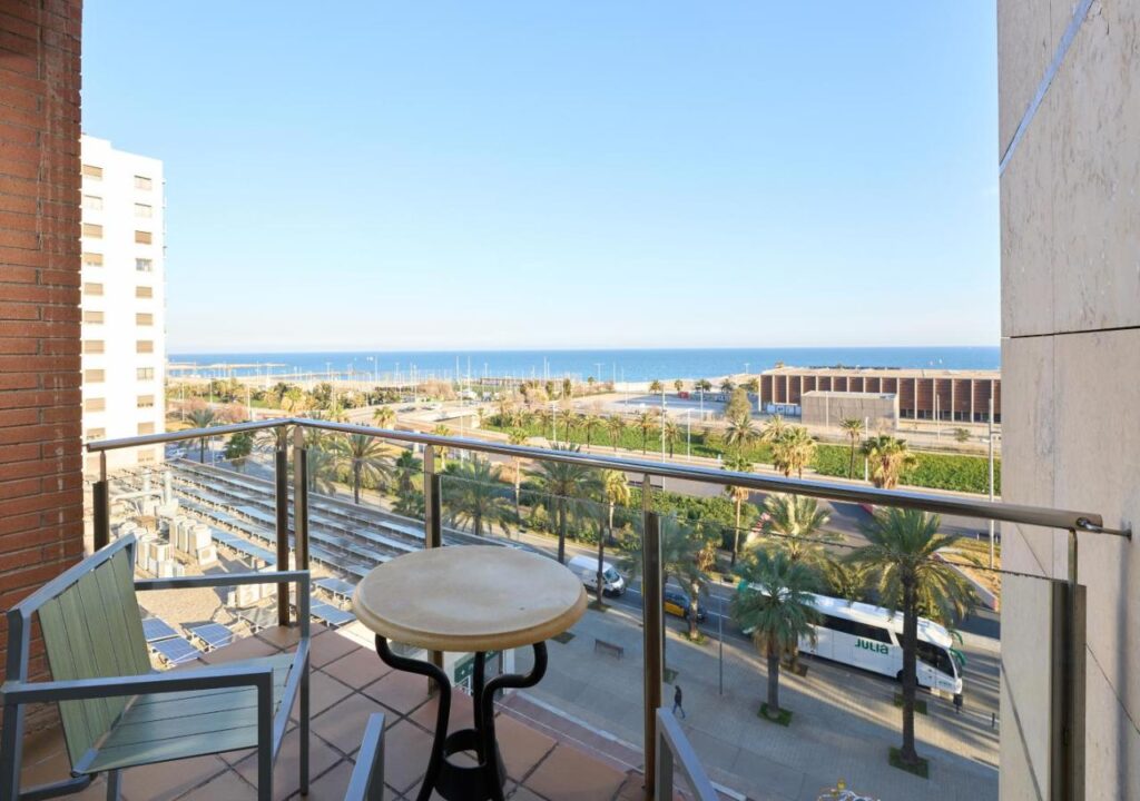 Scenic balcony view of the beach and palm trees, perfect for relaxation and enjoying coastal landscapes.