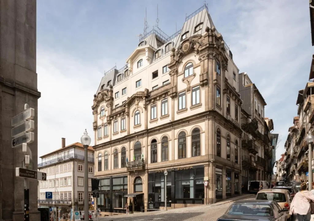 Elegant historical building on a city street, showcasing intricate architecture and a vibrant urban atmosphere.