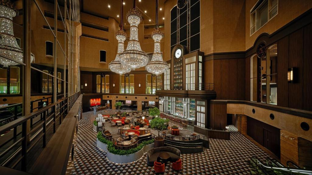 Luxurious hotel lobby with grand chandeliers, stylish seating, and elegant decor creating a welcoming atmosphere.