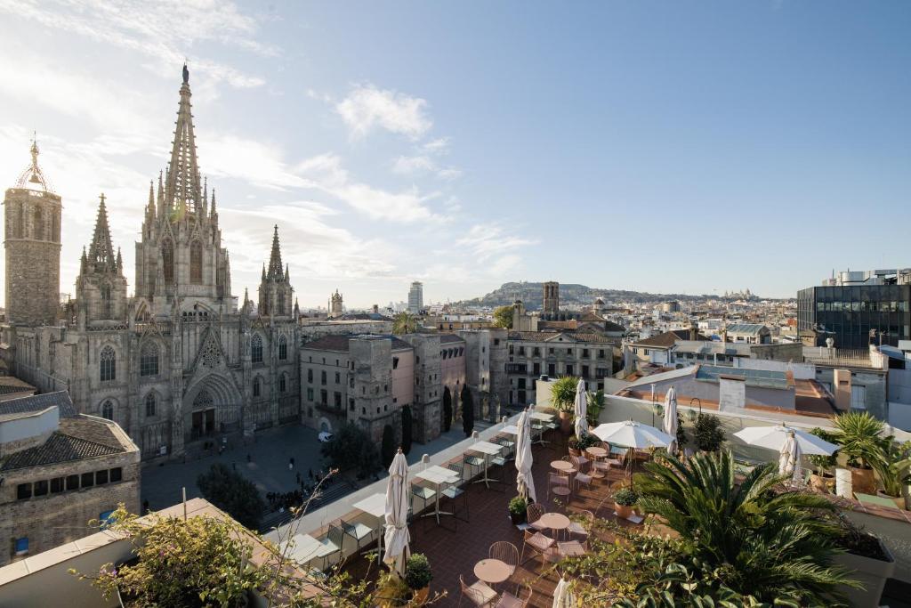 Rooftop view of Barcelona's Gothic Cathedral, showcasing stunning architecture and cityscape under a clear blue sky.