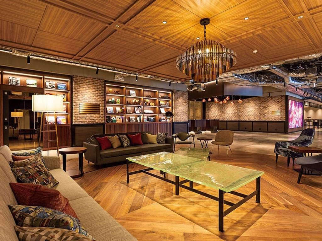 Stylish lounge area with wooden ceiling, modern furniture, and decorative shelves, creating a welcoming atmosphere.