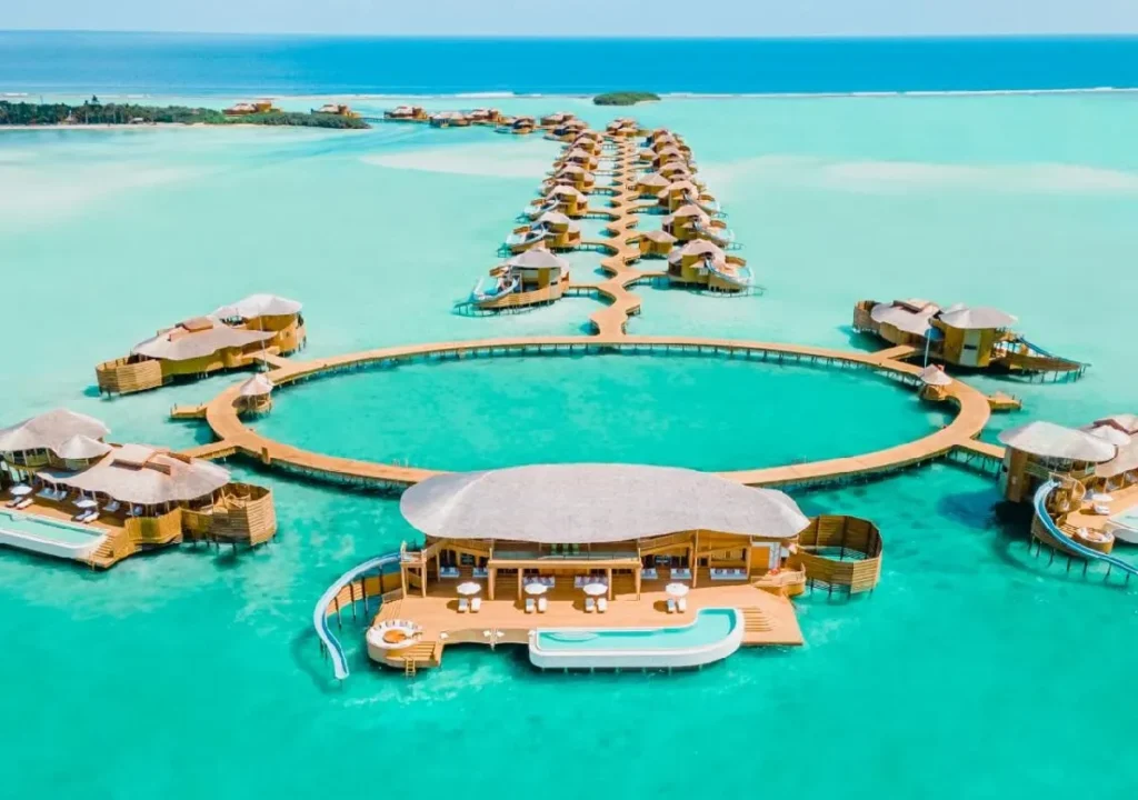 Luxurious overwater villas in a stunning turquoise lagoon, connected by wooden walkways, perfect for a tropical getaway.