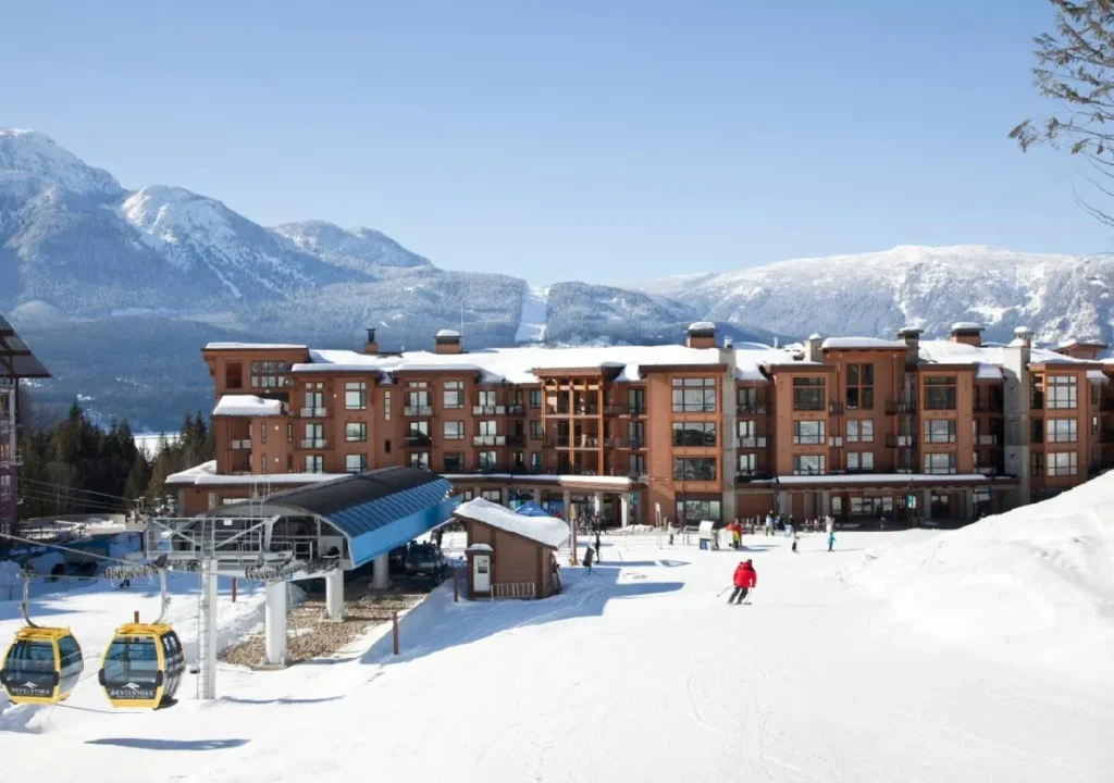 Ski resort with a lodge, gondola, and snowy mountains, offering winter adventures and stunning alpine views.