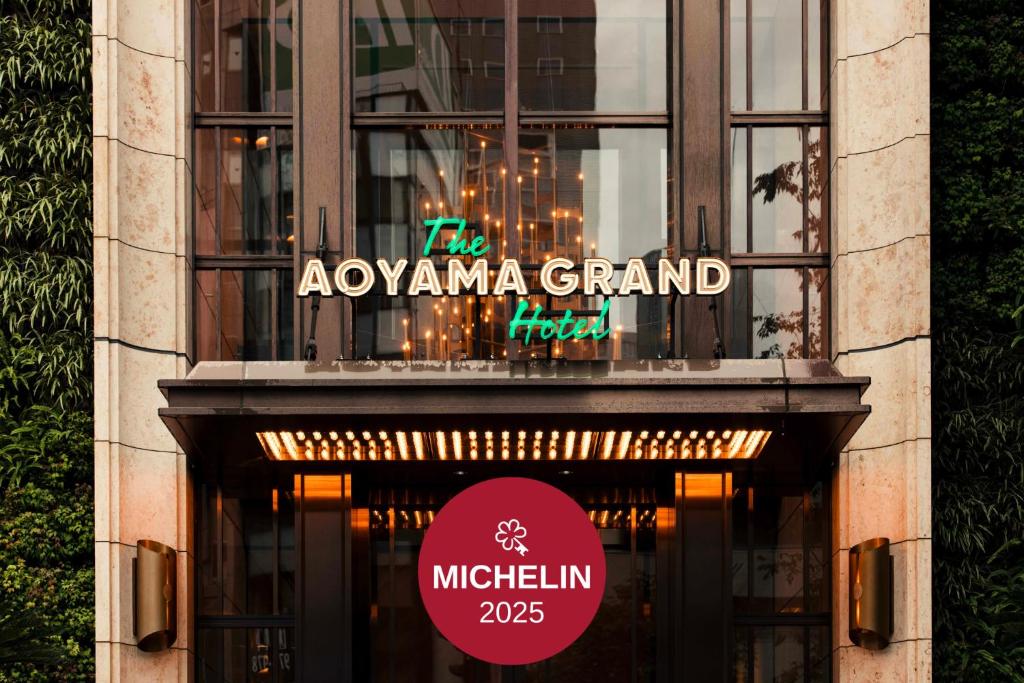 Elegant entrance of The Aoyama Grand Hotel with a Michelin 2025 insignia, showcasing luxury and modern design.
