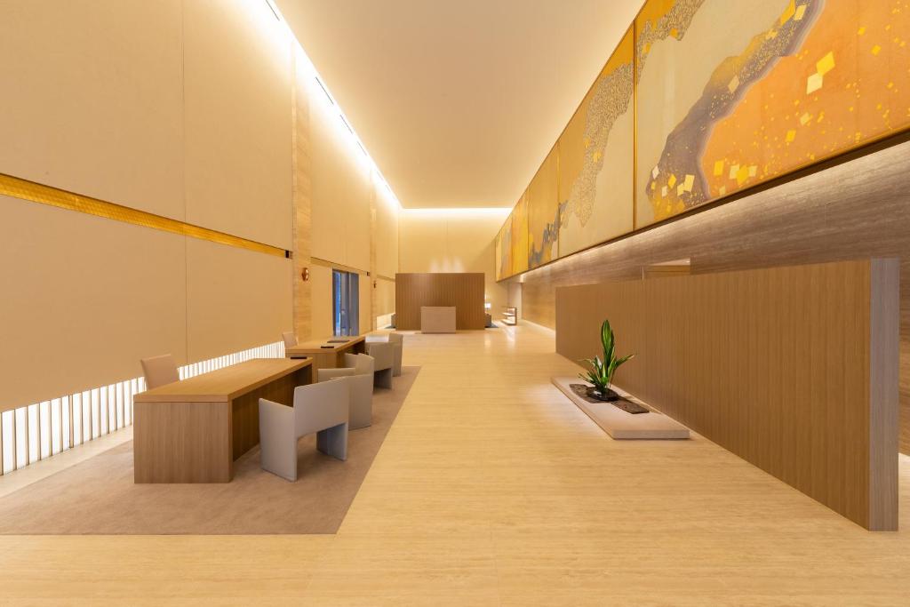 Modern office interior featuring sleek wooden furniture, vibrant artwork, and soft lighting for a tranquil atmosphere.