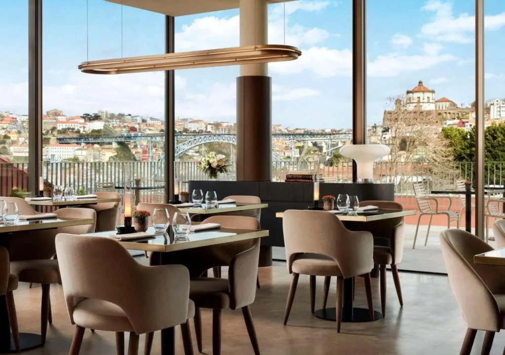 Modern restaurant interior with elegant seating and panoramic city views, perfect for fine dining experiences.