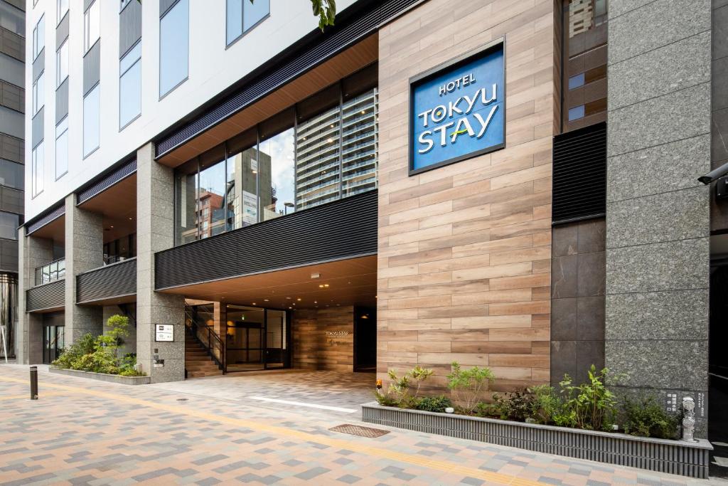 Exterior view of Hotel Tokyu Stay showcasing modern architecture and welcoming entrance in a city setting.