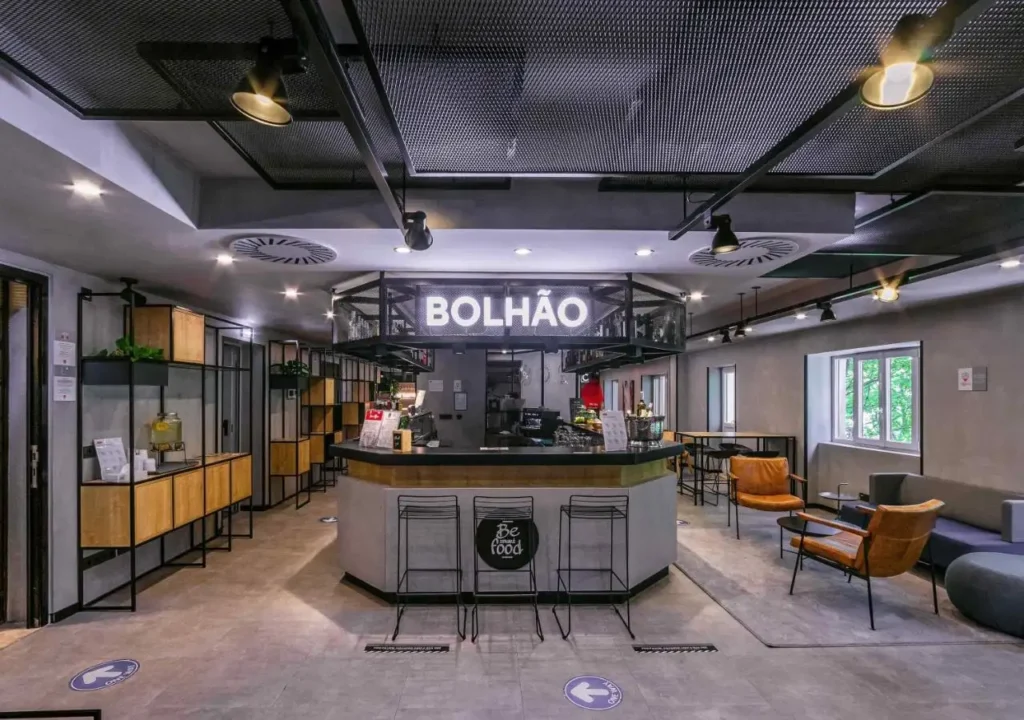 Interior view of Bolhão café featuring stylish decor, seating, and a welcoming atmosphere for guests.