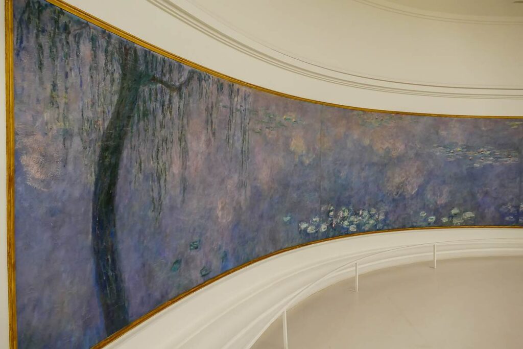 Panoramic view of Monet's Water Lilies painting, showcasing vibrant impressionist brushwork and serene natural beauty.