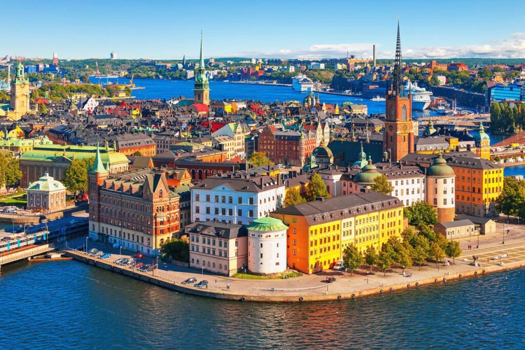 Colorful buildings and waterfront view of Stockholm, Sweden, showcasing historical architecture and vibrant cityscape.